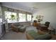Cozy sunroom features lots of natural light, desk, and comfortable wicker chairs with ottomans at 70 Glen Oaks Drive Dr, Youngsville, NC 27596