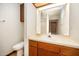 Bathroom featuring vanity with sink and mirror, a toilet and additional cabinet storage at 73 Stoneridge Rd, Durham, NC 27705