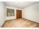 A simple bedroom with a window and closet doors, offering a blank canvas for personalization at 73 Stoneridge Rd, Durham, NC 27705