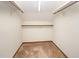 Empty closet with carpet and wooden rods with brackets for hanging clothes at 73 Stoneridge Rd, Durham, NC 27705