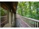 Spacious deck with wood flooring overlooks the surrounding wooded landscape at 73 Stoneridge Rd, Durham, NC 27705