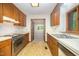 Well-lit kitchen boasts wood cabinets, and white countertops, offering functionality with views to dining room at 73 Stoneridge Rd, Durham, NC 27705