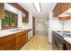 Functional kitchen features wood cabinets, white appliances and a pass-through to a bright dining space at 73 Stoneridge Rd, Durham, NC 27705