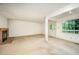 Spacious living room featuring neutral carpet and a brick fireplace, with access to outdoor spaces at 73 Stoneridge Rd, Durham, NC 27705