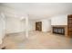 Large living room with a brick fireplace, neutral carpet, and open layout with structural columns at 73 Stoneridge Rd, Durham, NC 27705
