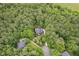 Overhead aerial view showing the house surrounded by dense, mature trees, creating a secluded and private setting at 7811 Still Crossing Rd, Chapel Hill, NC 27516
