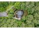 Aerial view highlighting a house nestled in lush greenery, showcasing privacy and landscaped grounds at 7811 Still Crossing Rd, Chapel Hill, NC 27516