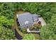 Aerial view of a private residence showing a well-maintained property surrounded by lush greenery and landscaping at 7811 Still Crossing Rd, Chapel Hill, NC 27516