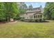 Expansive backyard features lush lawn, deck, shed, and well-maintained landscaping offering a private oasis at 7811 Still Crossing Rd, Chapel Hill, NC 27516