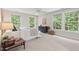Bright bedroom featuring a neutral color palette and tree views from windows at 7811 Still Crossing Rd, Chapel Hill, NC 27516