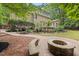 Inviting outdoor fire pit area with stone bench seating, perfect for entertaining in a tranquil setting at 7811 Still Crossing Rd, Chapel Hill, NC 27516