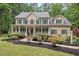 Inviting two-story home with a charming front porch and manicured landscaping at 7811 Still Crossing Rd, Chapel Hill, NC 27516
