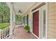 Relaxing front porch features a swing, ceiling fan, and classic columns at 7811 Still Crossing Rd, Chapel Hill, NC 27516