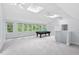Spacious game room with pool table, skylights, and ample natural light from large windows at 7811 Still Crossing Rd, Chapel Hill, NC 27516