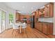 Eat-in kitchen with stainless steel appliances, granite countertops, tile backsplash, and breakfast table near the window at 7811 Still Crossing Rd, Chapel Hill, NC 27516