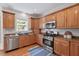 Modern kitchen features stainless steel appliances, granite countertops, and ample cabinet space at 7811 Still Crossing Rd, Chapel Hill, NC 27516