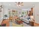 Bright living room flows into a sunroom, offering hardwood floors and ample seating at 7811 Still Crossing Rd, Chapel Hill, NC 27516