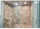 Tiled shower features glass doors, overhead shower head and built-in bench at 7811 Still Crossing Rd, Chapel Hill, NC 27516