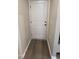 Entryway with a white paneled door, neutral walls, and trim details, leading to the rest of the home at 803 Courting St, Apex, NC 27523