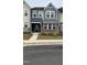 Attractive townhouse exterior features a stone and siding facade with landscaped lawn at 803 Courting St, Apex, NC 27523