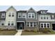 Charming townhome displaying a contemporary design, complemented by neat landscaping and stone accents at 803 Courting St, Apex, NC 27523