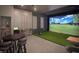 Entertainment room with golf simulator, sports games, large screen, and comfortable seating at 803 Courting St, Apex, NC 27523
