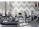 Well-equipped gym featuring treadmills, elliptical machines, and free weights in a naturally lit space at 803 Courting St, Apex, NC 27523