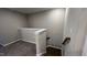 Neutral hallway showing access to the upper and lower floors of the home at 803 Courting St, Apex, NC 27523