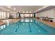 Bright indoor pool with lap lanes and ample lounge seating, perfect for year-round enjoyment at 803 Courting St, Apex, NC 27523