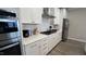 Well-lit kitchen featuring white cabinets, quartz countertops, white subway tile backsplash, and stainless steel appliances at 803 Courting St, Apex, NC 27523