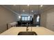 Bright view from a sink to the living room featuring a sofa and tv at 803 Courting St, Apex, NC 27523