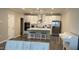 Modern kitchen featuring quartz counters, island with bar stools and white cabinets at 803 Courting St, Apex, NC 27523