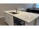 White quartz countertop island with a stainless steel sink and dishwasher in a bright, modern kitchen area at 803 Courting St, Apex, NC 27523