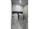 Laundry room with white cabinets, tile flooring and modern washer and dryer at 803 Courting St, Apex, NC 27523
