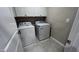 Functional laundry room with white cabinets and modern washer and dryer at 803 Courting St, Apex, NC 27523