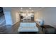 Open-concept living space with kitchen island and white futon at 803 Courting St, Apex, NC 27523