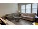 Cozy living room with plush sofas, a glass coffee table, and neutral décor at 803 Courting St, Apex, NC 27523