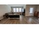 Open living room with hardwood floors, lots of natural light, and neutral decor at 803 Courting St, Apex, NC 27523