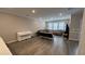 Spacious living room featuring hardwood floors, neutral paint, and plenty of natural light from the large windows at 803 Courting St, Apex, NC 27523