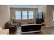 Bright living room featuring hardwood floors, neutral paint, and lots of natural light coming from the large windows at 803 Courting St, Apex, NC 27523