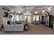 Enjoy the fireplace and lovely furniture in this community living room with lots of natural light at 803 Courting St, Apex, NC 27523