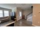 Open-concept living room with hardwood floors, a staircase, and natural light at 803 Courting St, Apex, NC 27523