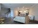 Open-concept floorplan with staircase, living room and kitchen with island at 803 Courting St, Apex, NC 27523