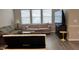 Bright living room featuring hardwood floors, comfortable seating, and large windows at 803 Courting St, Apex, NC 27523