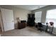 Office space features neutral carpet, windows, desk, and shelves at 803 Courting St, Apex, NC 27523