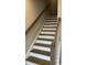 Elegant staircase with wooden treads and white risers, showcasing craftsmanship and attention to detail at 803 Courting St, Apex, NC 27523