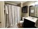 Bathroom with a shower/tub combo featuring a gray and white patterned shower curtain at 8620 Brookdale Dr, Raleigh, NC 27613