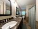 Spacious bathroom featuring double sinks, granite countertops, and a shower with decorative shower curtain at 8620 Brookdale Dr, Raleigh, NC 27613