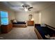 Bedroom featuring two beds, carpet floors, a ceiling fan, and natural light from the window at 8620 Brookdale Dr, Raleigh, NC 27613