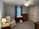 Bedroom with a crib, dresser, changing table, plush chair, and ceiling fan at 8620 Brookdale Dr, Raleigh, NC 27613